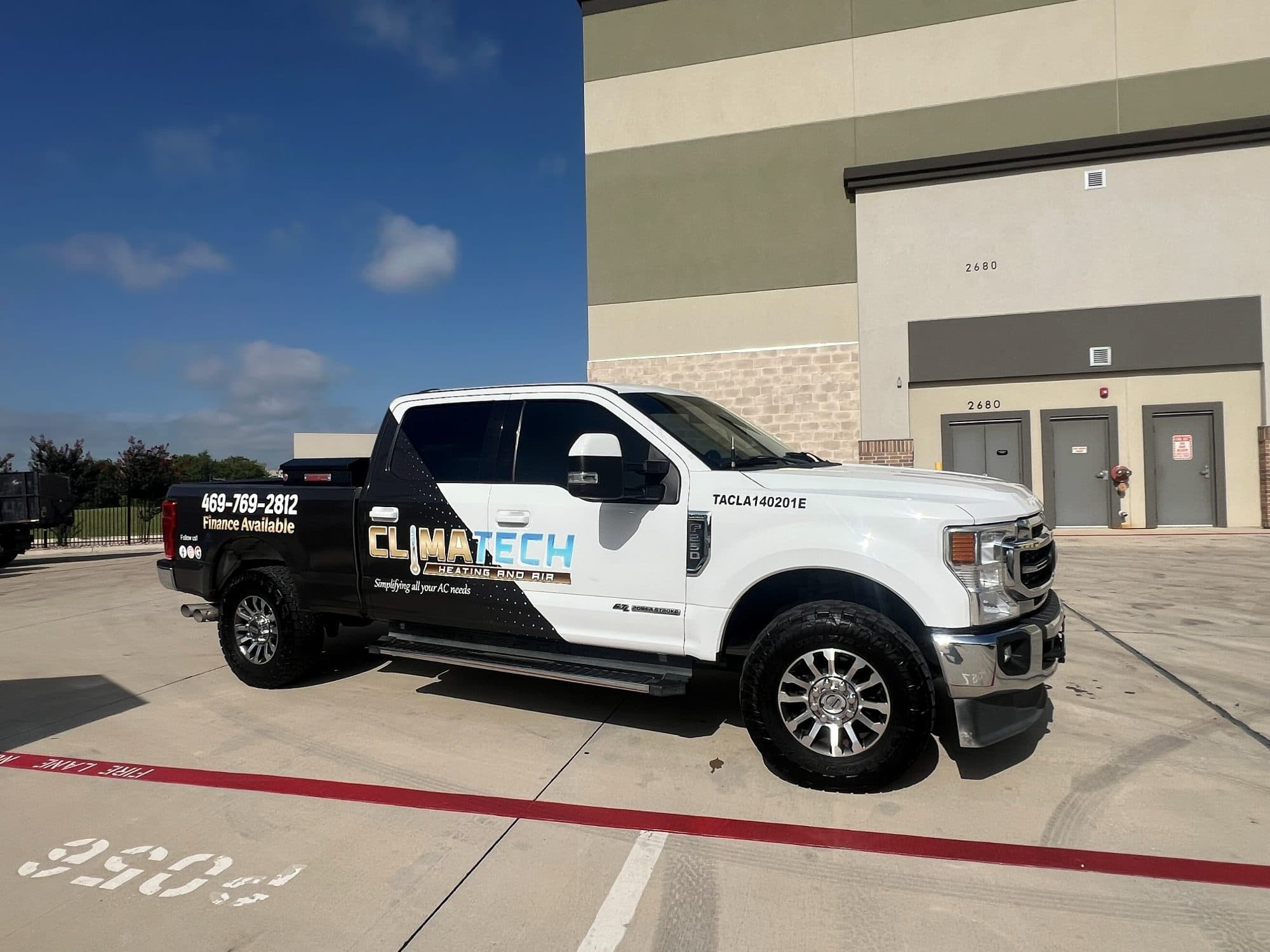 The Climatech Heating and Air wrapped F-250, phone number 469-769-2812 painted on the bed