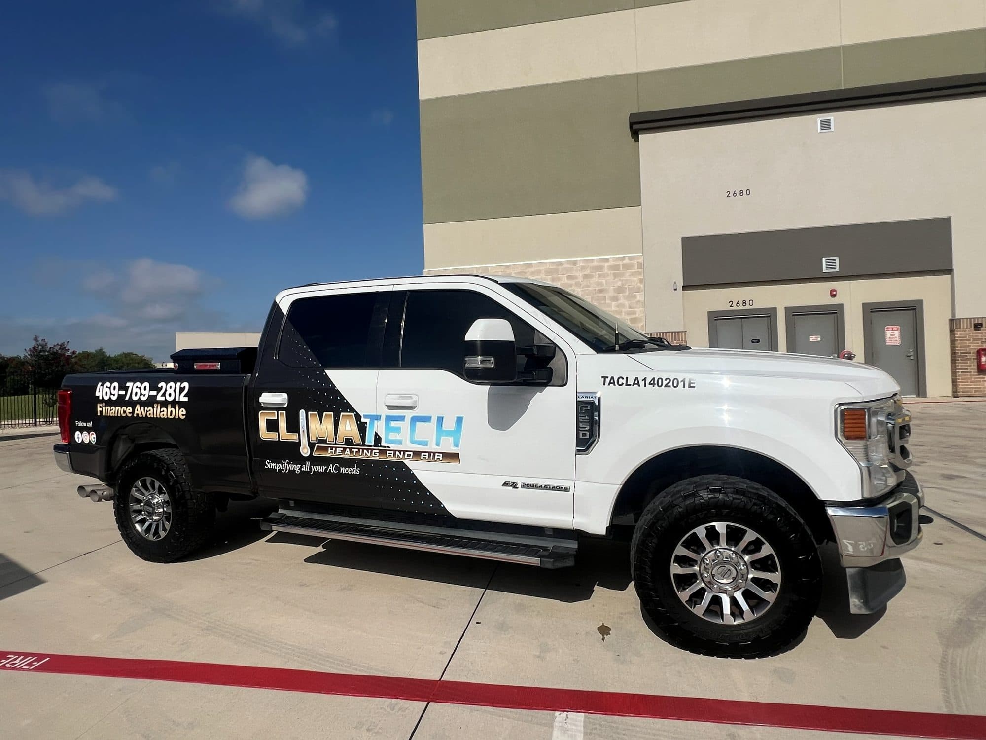 The Climatech Heating and Air wrapped F-250 service truck, license TACLA140201E painted on the door